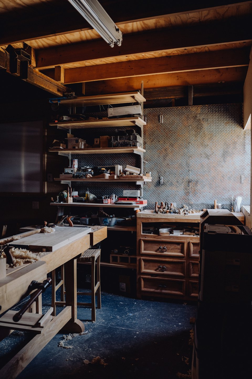 Woodworking shop workbench with tools and supplies.