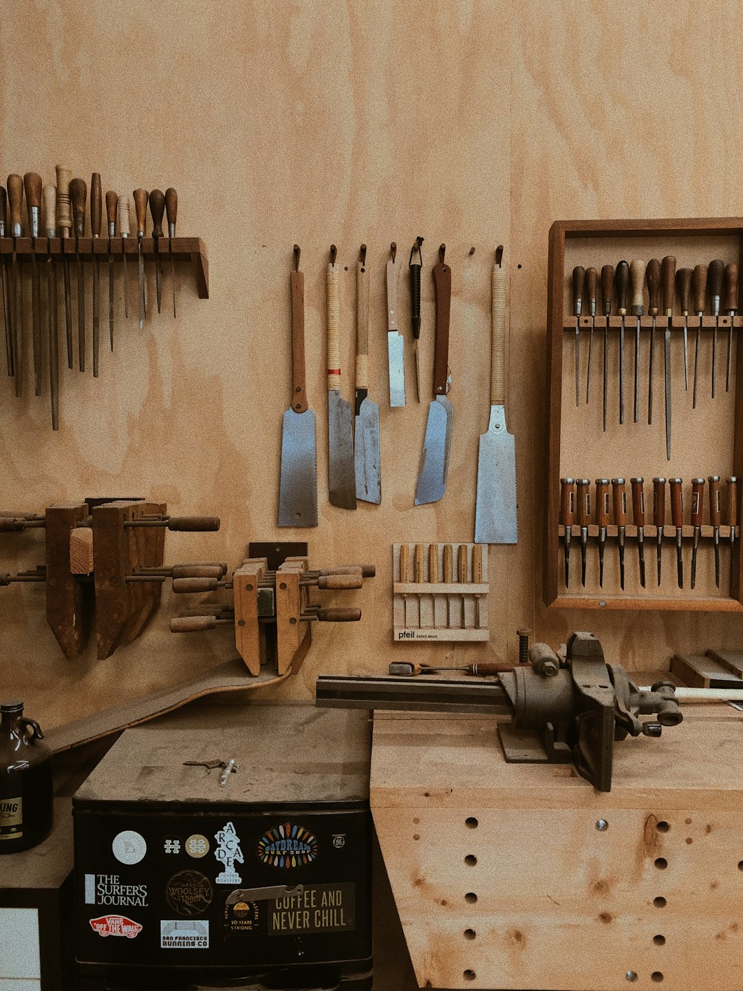 Woodworking tools neatly arranged on a workshop wall.